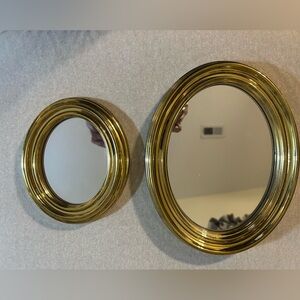 2 oval mirrors with wall hanging hooks.